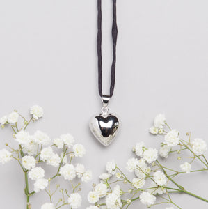 silver plated heart shaped Mexican bola pregnancy necklace with black hand dyed silk cord