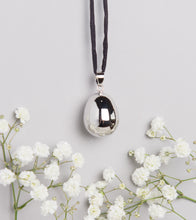 Load image into Gallery viewer, silver plated pebble Mexican bola pregnancy necklace on black hand dyed silk cord