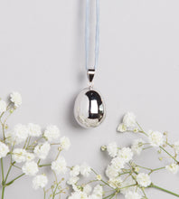 Load image into Gallery viewer, silver plated pebble shaped Mexican bola pregnancy necklace on light grey hand dyed silk cord