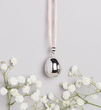 Load image into Gallery viewer, silver plated pebble Mexican bola pregnancy necklace on baby pink hand dyed silk cord