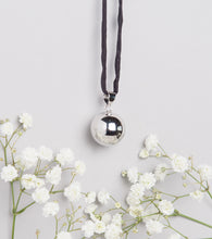 Load image into Gallery viewer, polished silver plated Mexican bola pregnancy necklace on black hand dyed silk cord