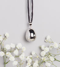 Load image into Gallery viewer, silver plated pebble Mexican bola pregnancy necklace on black hand dyed silk cord
