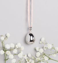 Load image into Gallery viewer, silver plated pebble Mexican bola pregnancy necklace on baby pink hand dyed silk cord
